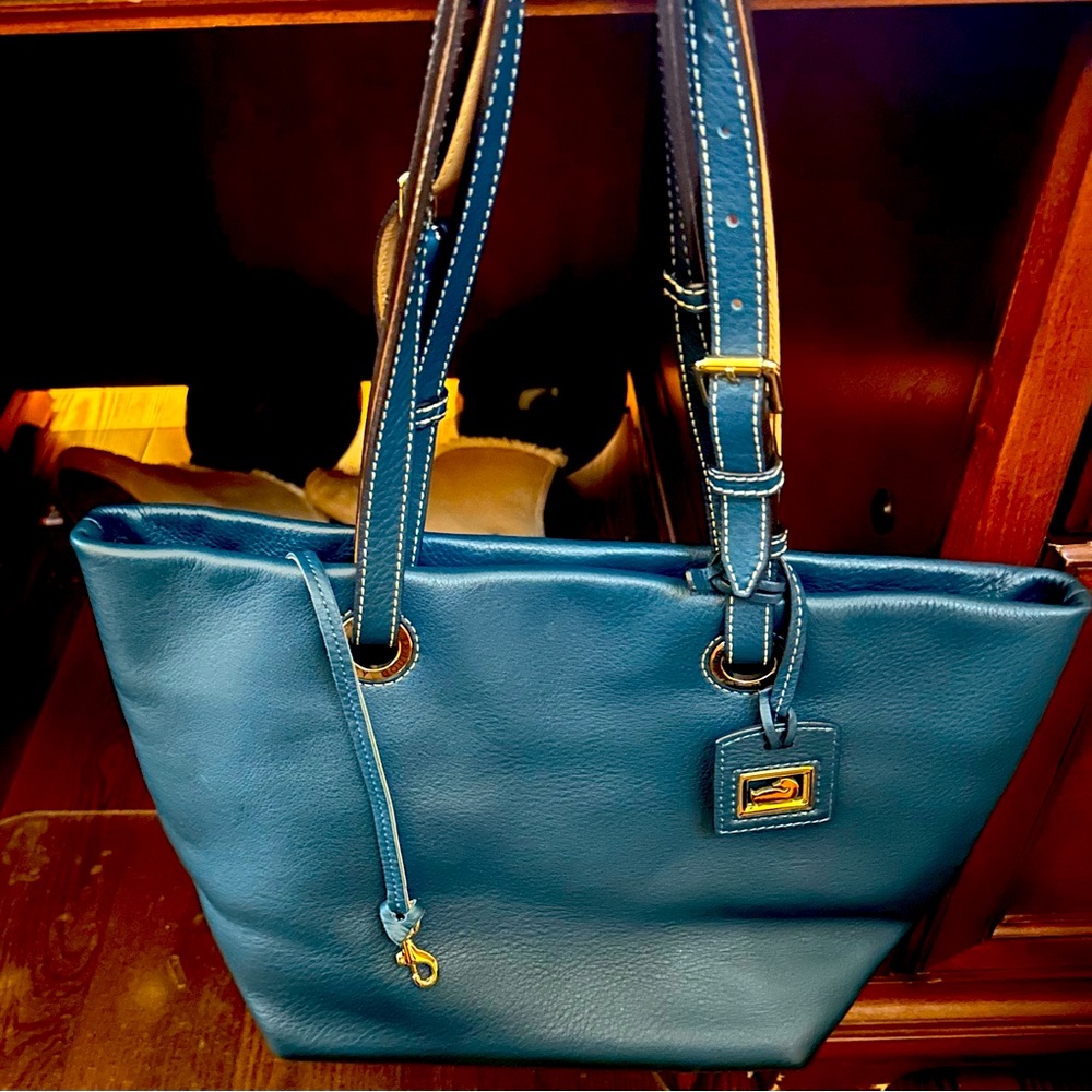 Dooney & Bourke Dark Teal Pebble Leather with a magnetic closure